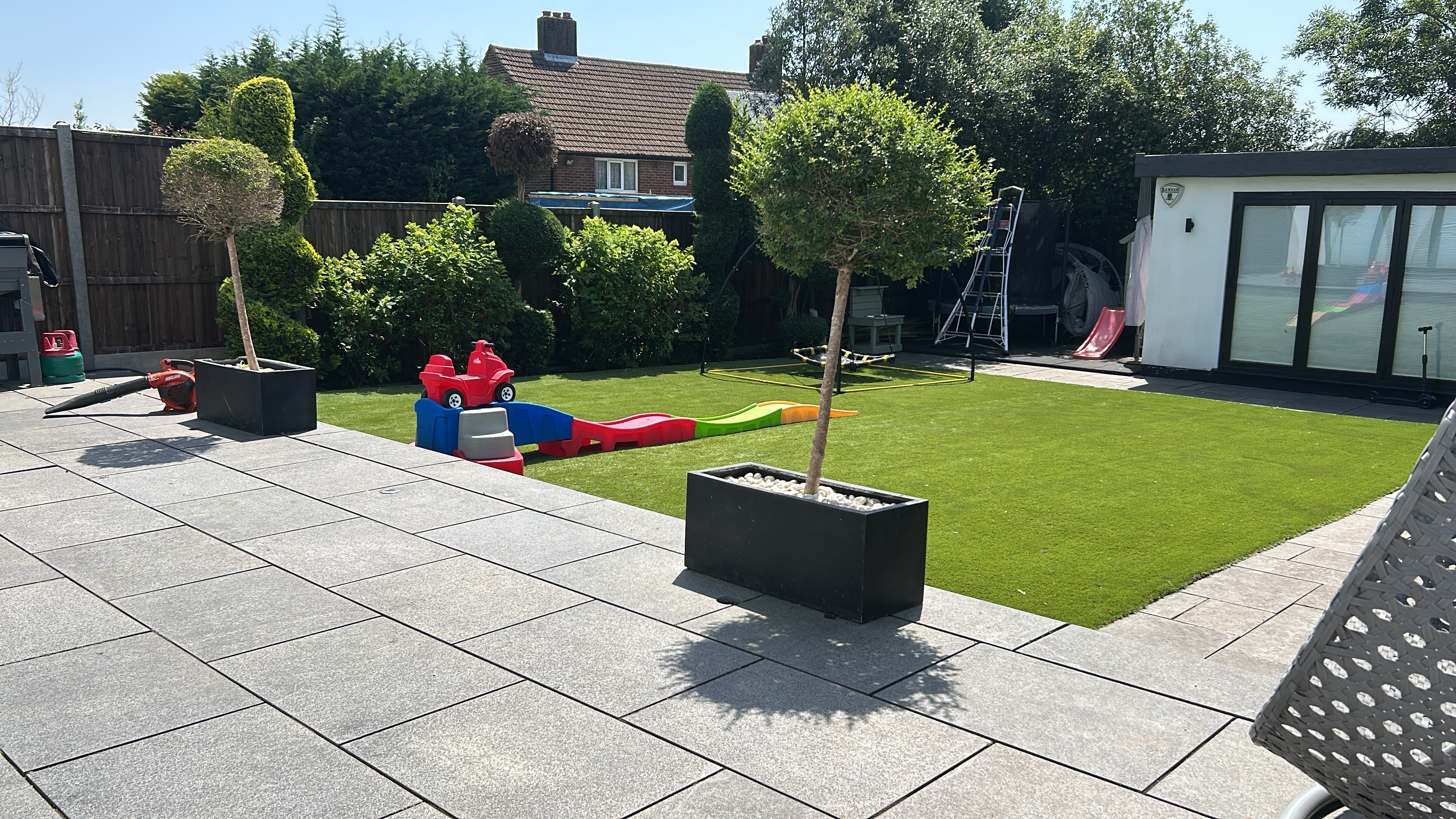 Gardener pruning flowering plants in a residential garden